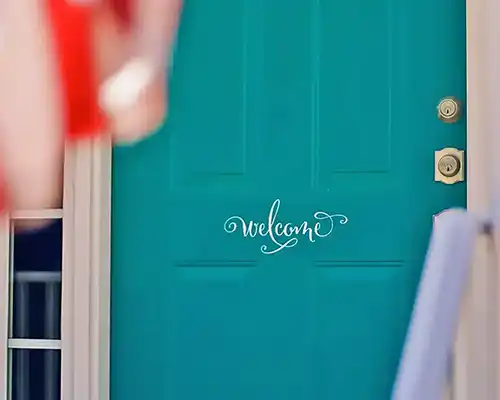 A teal door with a welcome sign of a nice home in The Woods at Summerford, Chesterfield, VA